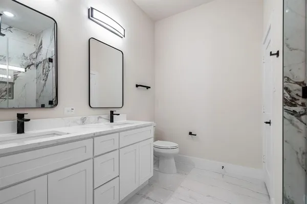 a bathroom with 2 sink and a mirror