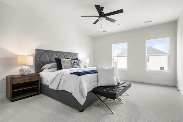 a bedroom with a bed and a chandelier