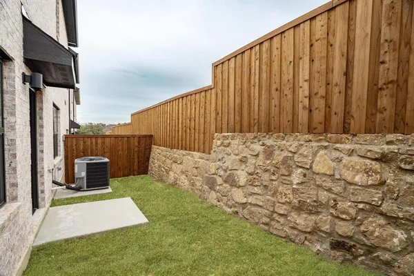 a view of a backyard with wooden fence