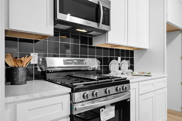 a stove top oven sitting inside of a kitchen