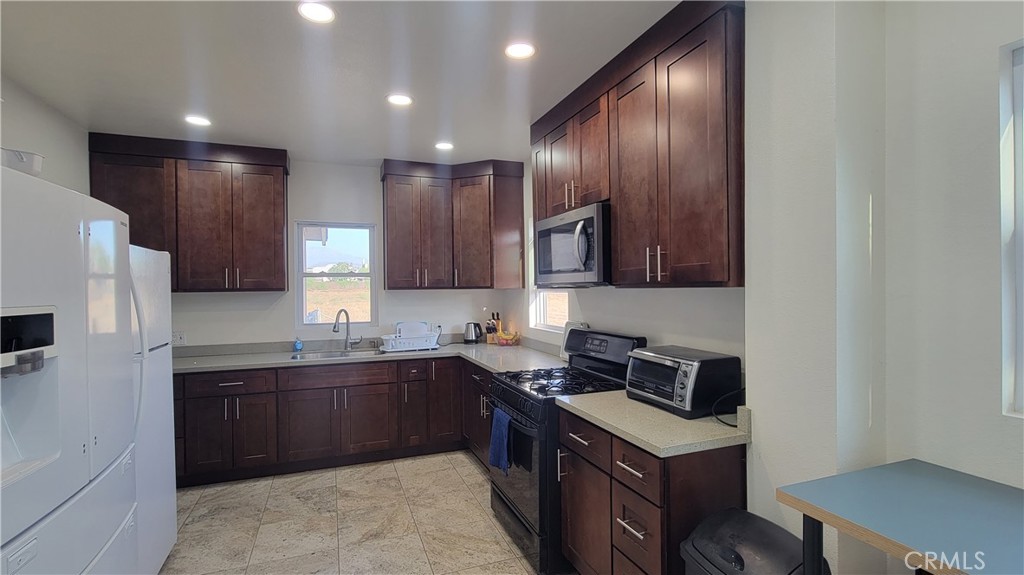 503 West Colton Avenue Redlands, CA 92374 - Photo 4 of 18 a kitchen with a sink stove and refrigerator
