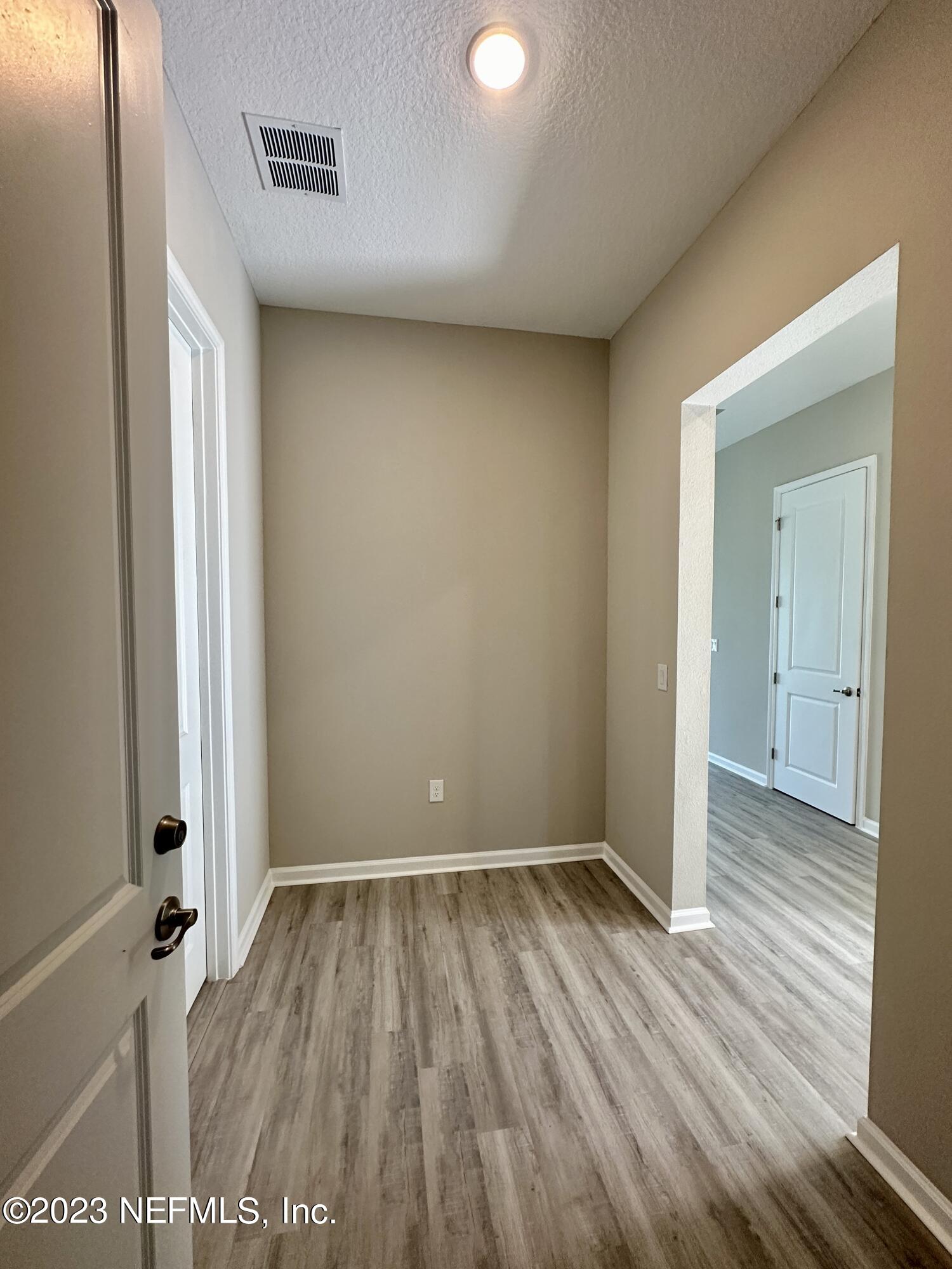 9 Jackson Blue Place Palm Coast, FL 32137 - Photo 12 of 21 a view of an empty room with wooden floor and a window