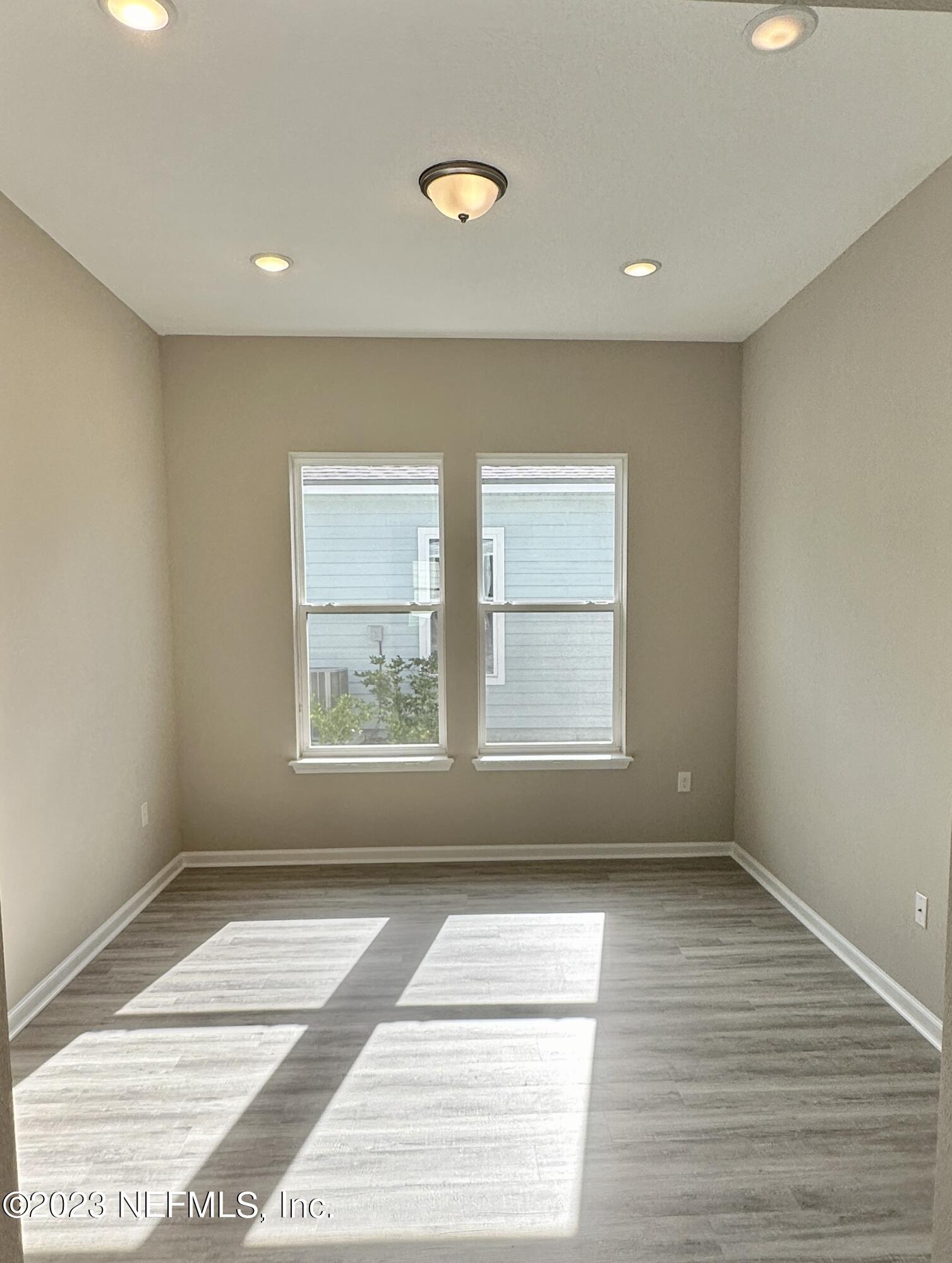 9 Jackson Blue Place Palm Coast, FL 32137 - Photo 3 of 21 a view of an empty room with wooden floor and window
