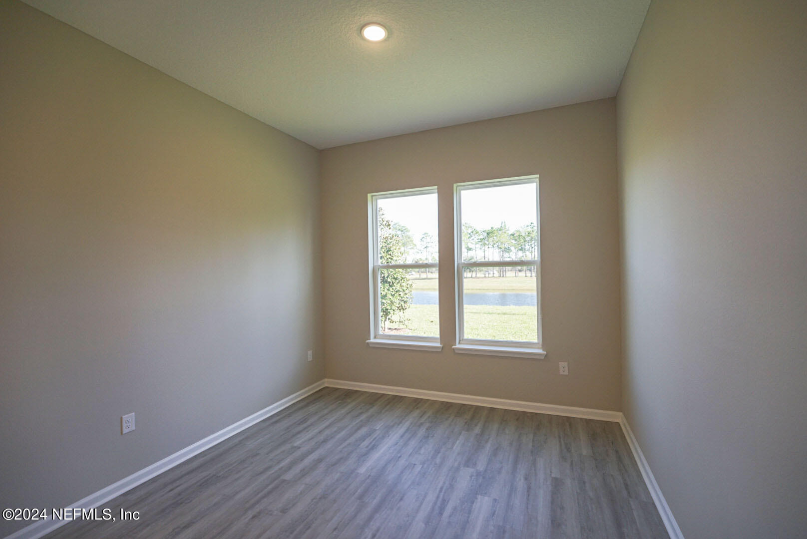 9 Jackson Blue Place Palm Coast, FL 32137 - Photo 7 of 21 an empty room with wooden floor and windows