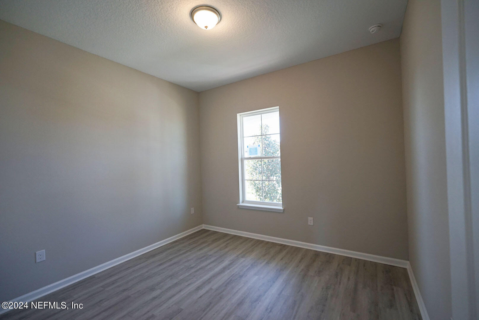 9 Jackson Blue Place Palm Coast, FL 32137 - Photo 8 of 21 an empty room with wooden floor and windows