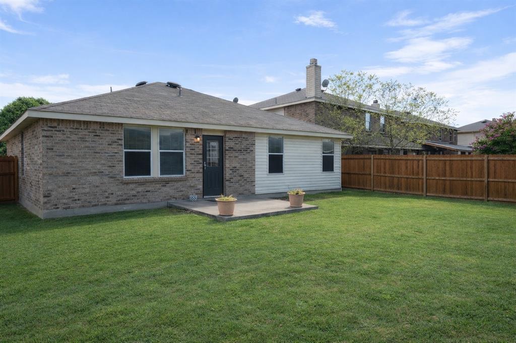 1621 Carolina Ridge Way Fort Worth, TX 76247 - Photo 7 of 7 Back of property with a patio, a fenced backyard, a chimney, and brick siding