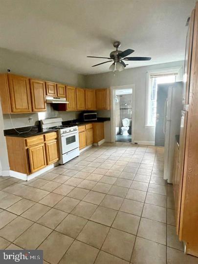 a large kitchen with cabinets and a window
