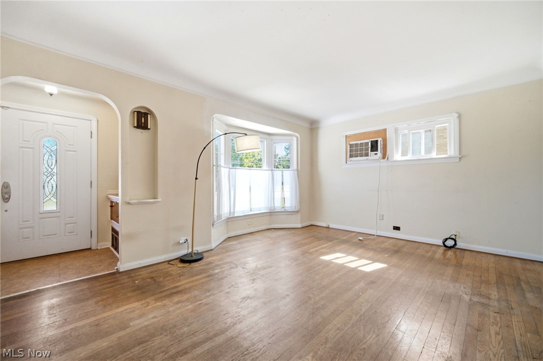5003 West Ridgewood Drive Parma, OH 44134 - Photo 7 of 25 Bright and cheery living room features wood floors and entry foyer