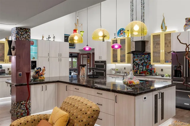 a kitchen area with granite countertop a sink and cabinets
