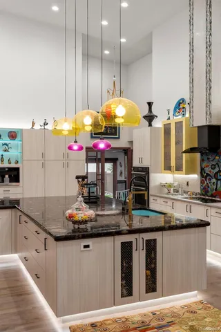 a kitchen with stainless steel appliances kitchen island granite countertop a stove a sink and a refrigerator