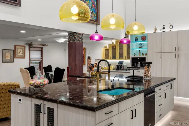 a kitchen with granite countertop a sink cabinets and window