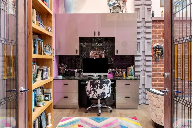 a living room with fireplace furniture and a book shelf