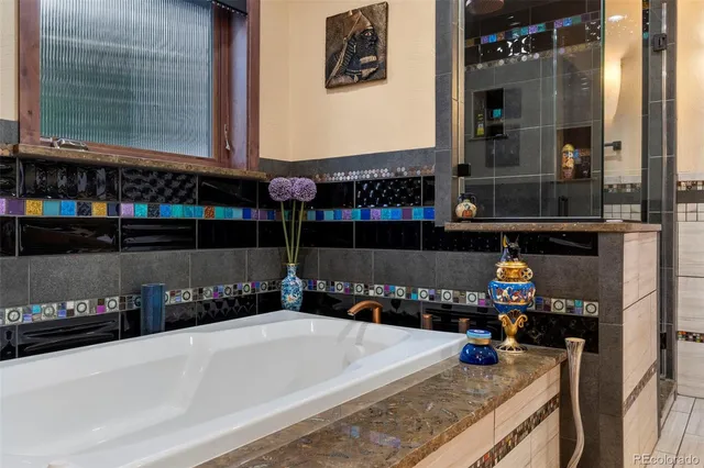 a bathroom with a granite countertop sink a mirror and shower
