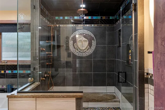 a bathroom with a granite countertop sink a mirror and vanity