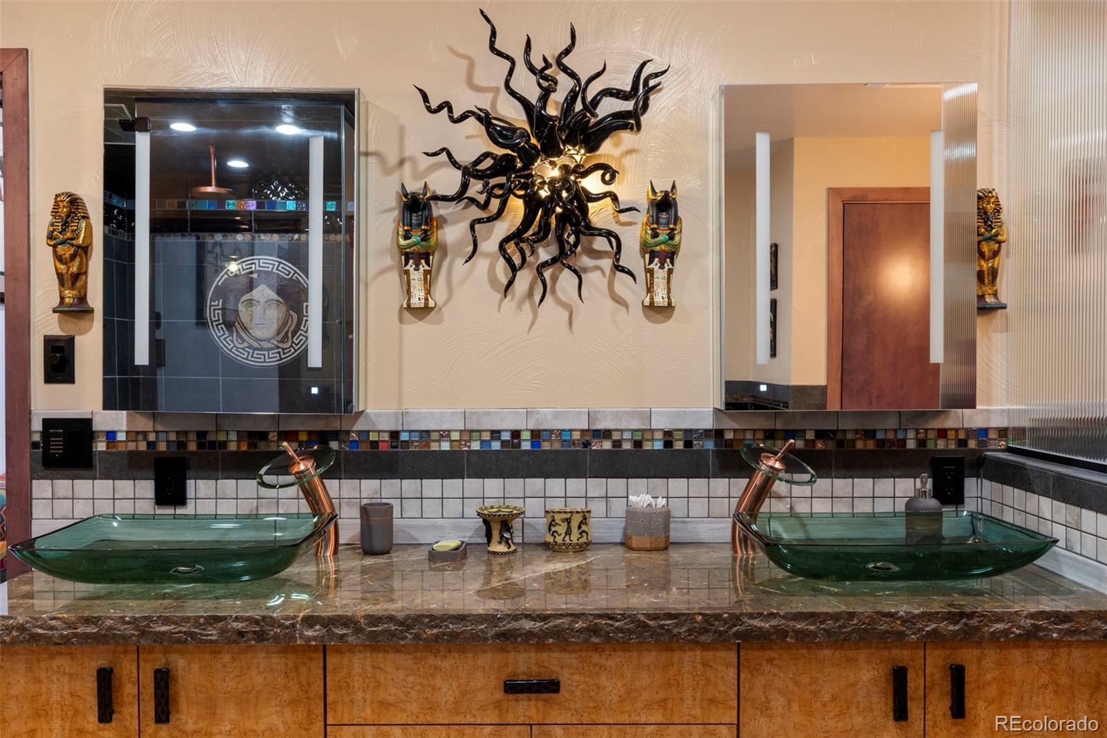 4541 Reed Street Wheat Ridge, CO 80033 - Photo 26 of 43 a bathroom with a granite countertop sink a mirror and vanity