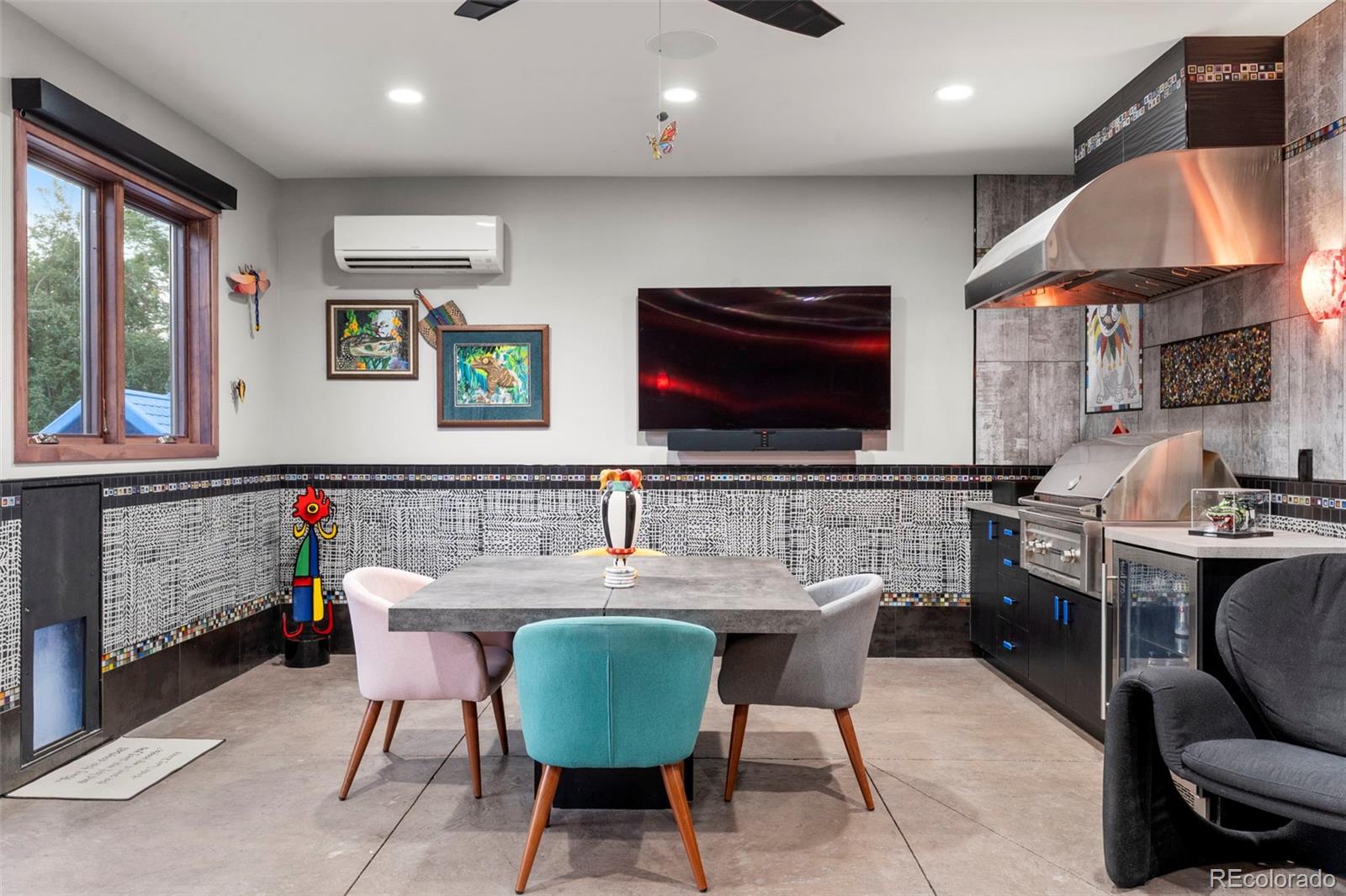 4541 Reed Street Wheat Ridge, CO 80033 - Photo 30 of 43 a dining room with furniture a window and a flat screen tv