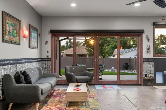 a living room with kitchen island furniture and a kitchen view