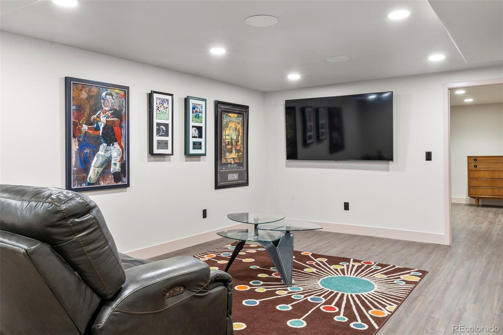 4541 Reed Street Wheat Ridge, CO 80033 - Photo 36 of 43 a living room with furniture and a flat screen tv