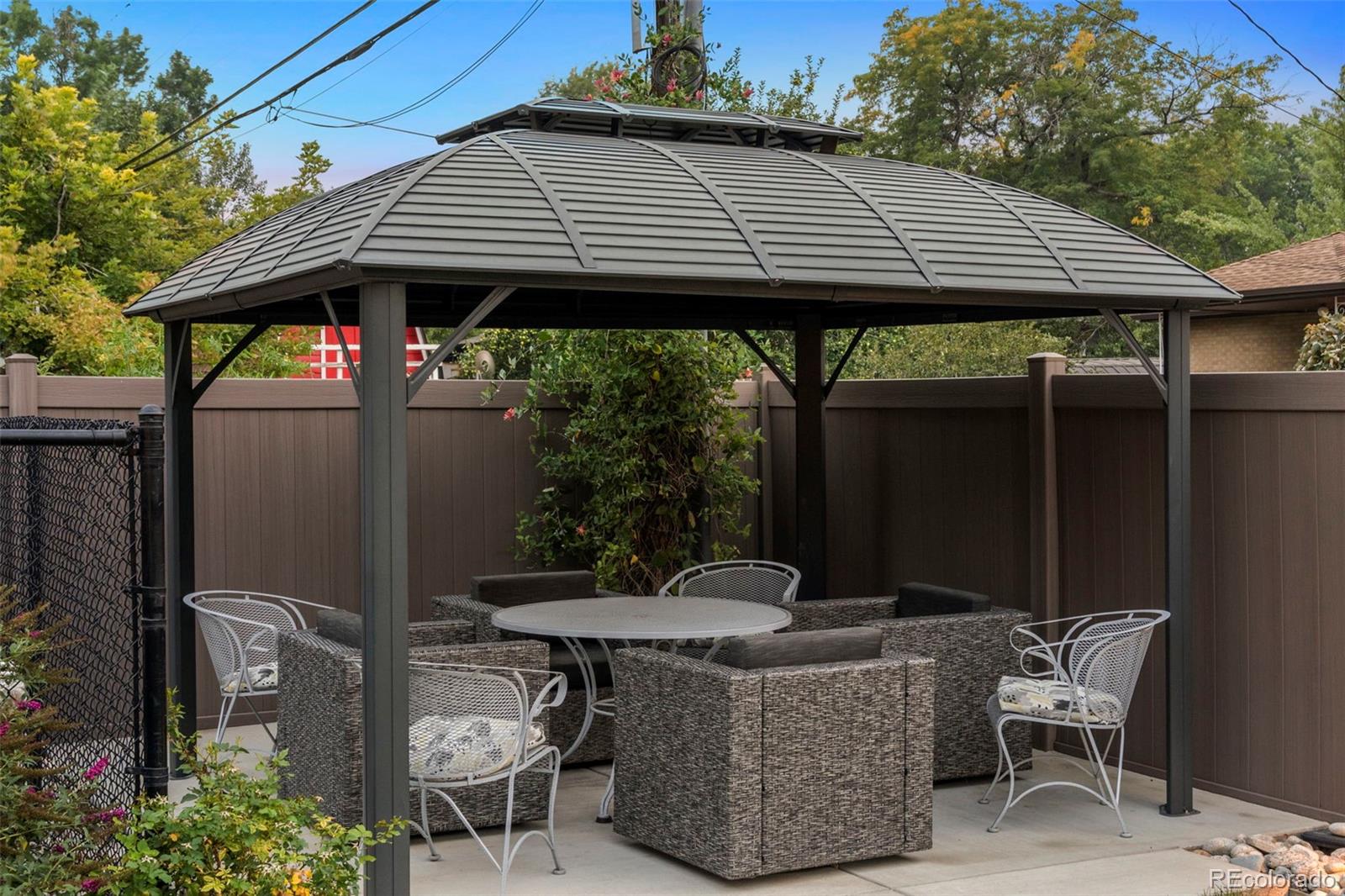 4541 Reed Street Wheat Ridge, CO 80033 - Photo 37 of 43 a backyard of a house with table and chairs