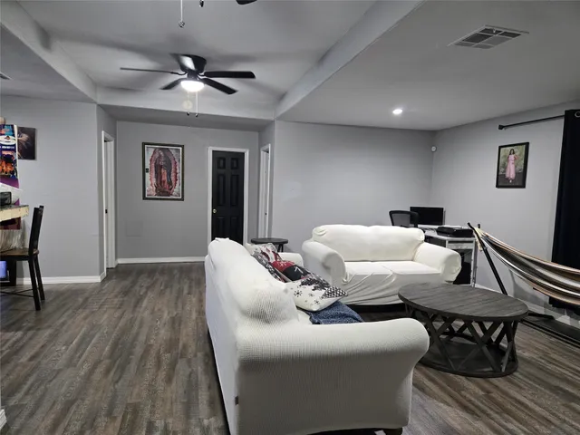 a bedroom with furniture and a wooden floor