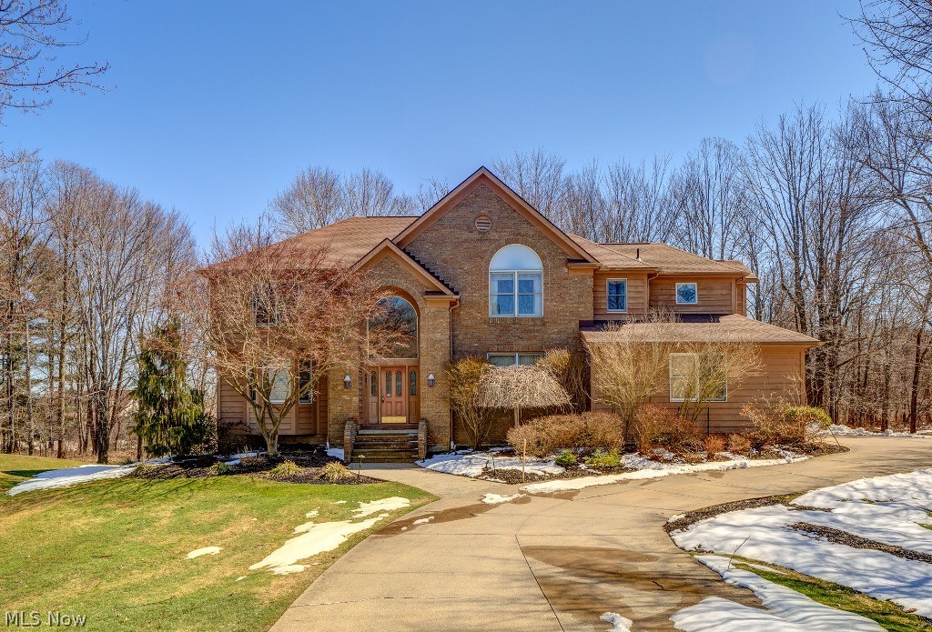 5571 High Point Road Solon, OH 44139 - Photo 2 of 34 Wonderful brick and cedar transitional style with 3 car garage and private park-like setting.