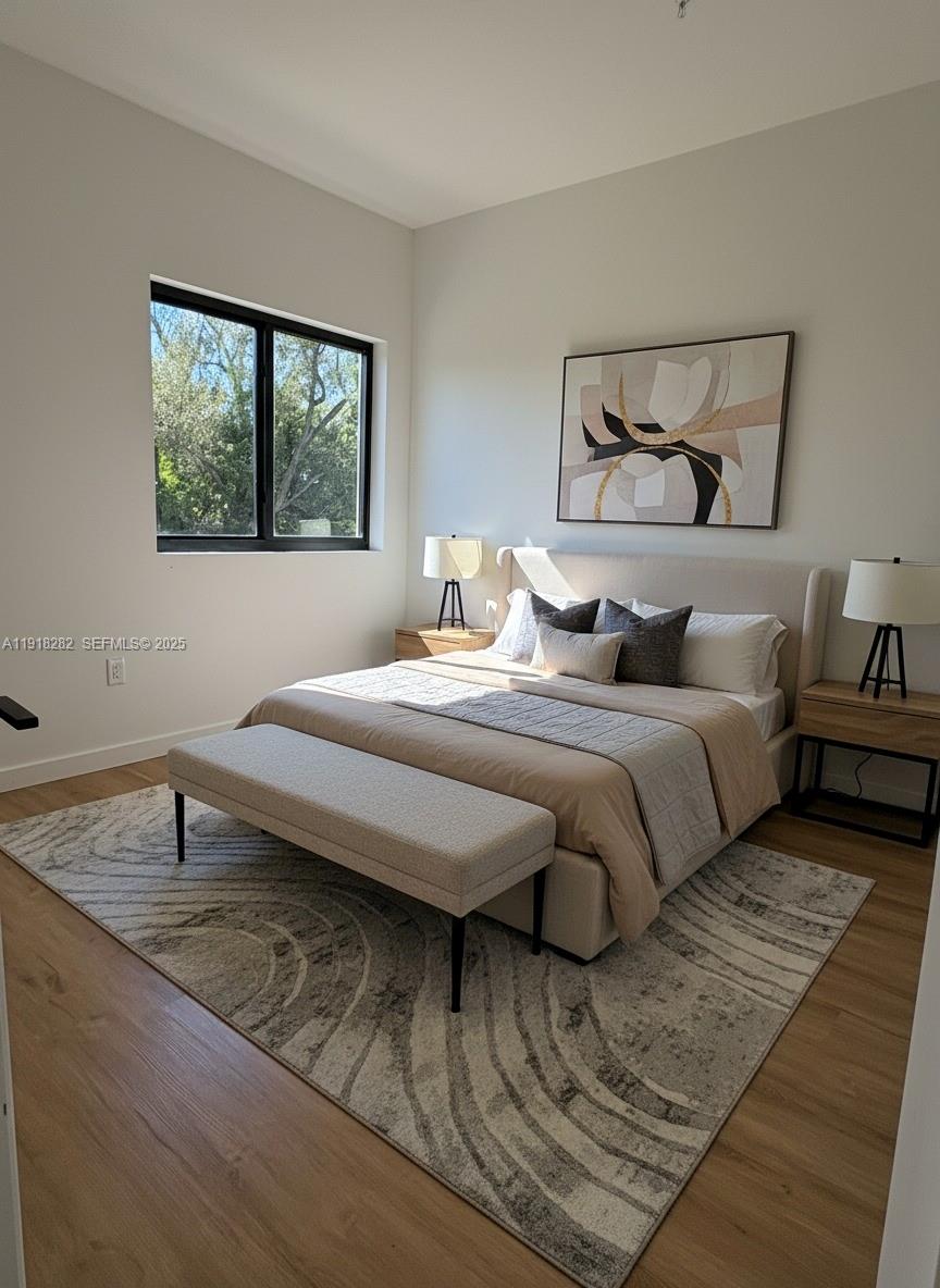 85 Northeast 55th Street, Unit 5 Miami, FL 33137 - Photo 3 of 14 a bedroom with double bed and a window