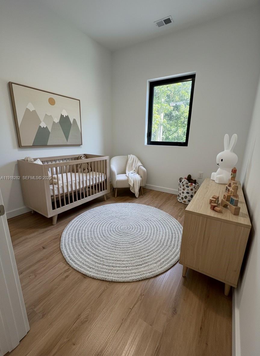 85 Northeast 55th Street, Unit 5 Miami, FL 33137 - Photo 5 of 14 a bedroom with furniture and a window