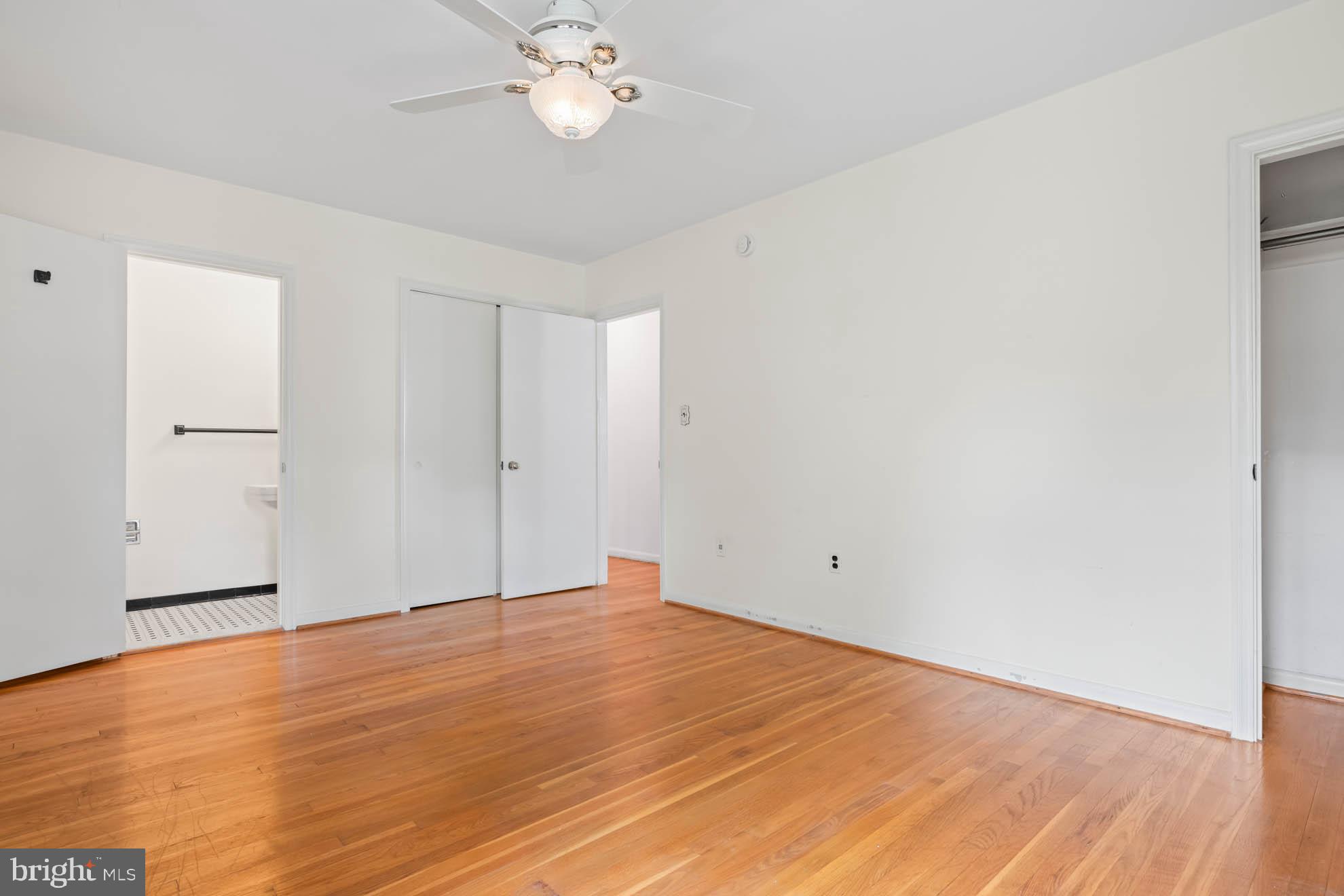 210 Rothwell Drive Lutherville-Timonium, MD 21093 - Photo 19 of 48 an empty room with wooden floor and chandelier fan