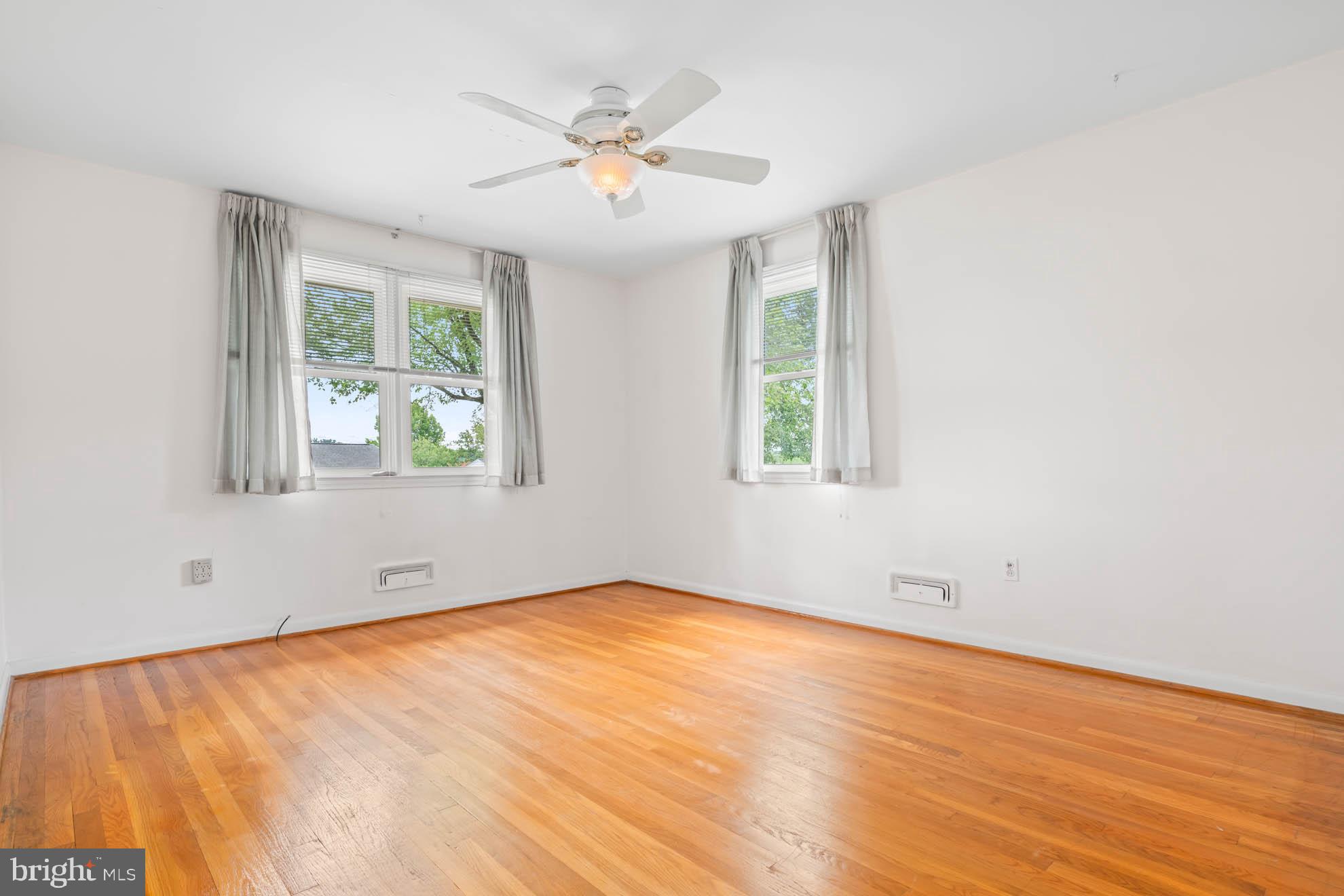 210 Rothwell Drive Lutherville-Timonium, MD 21093 - Photo 23 of 48 an empty room with wooden floor and windows