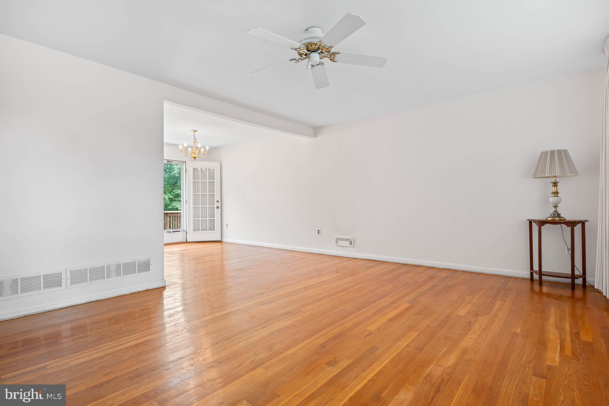 210 Rothwell Drive Lutherville-Timonium, MD 21093 - Photo 7 of 48 a view of an empty room with wooden floor and a window