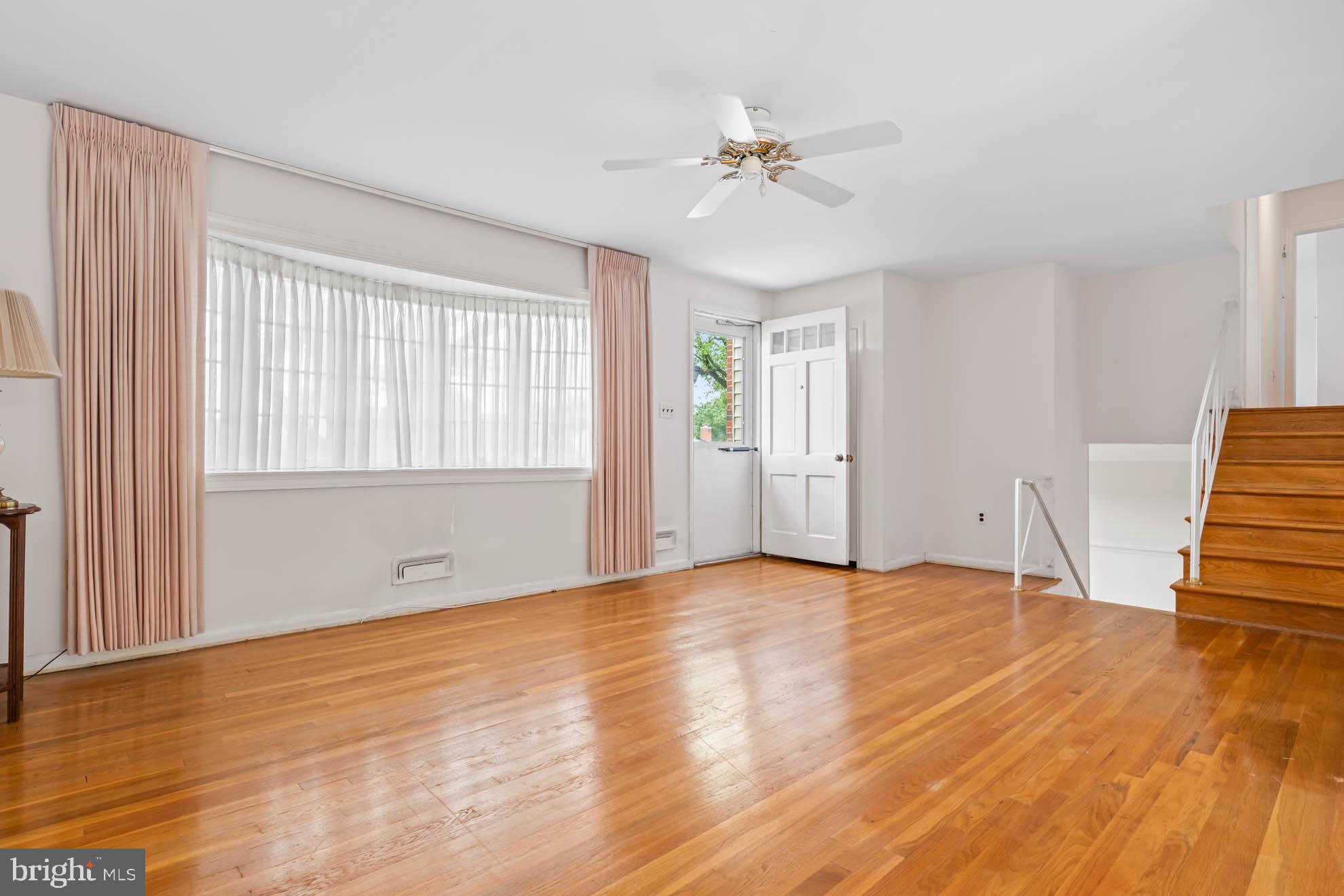 210 Rothwell Drive Lutherville-Timonium, MD 21093 - Photo 9 of 48 a view of an empty room with wooden floor and a window