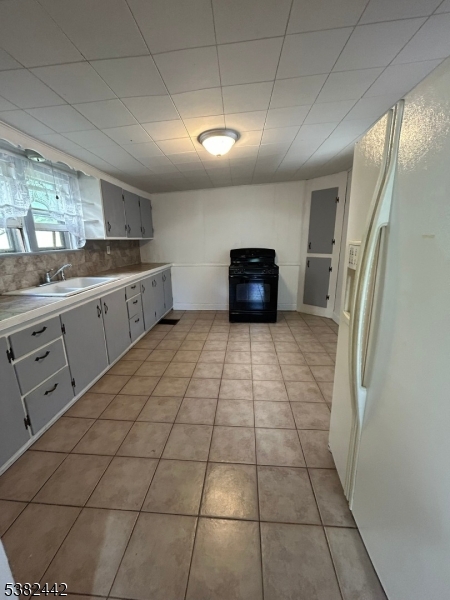 100 Myrtle Avenue Washington, NJ 07882 - Photo 13 of 37 a large white kitchen with a sink a counter top space and stainless steel appliances