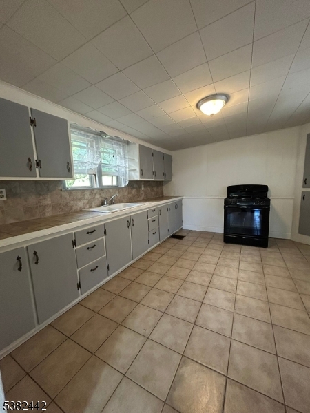 100 Myrtle Avenue Washington, NJ 07882 - Photo 14 of 37 a kitchen with stainless steel appliances a sink a stove a microwave and cabinets