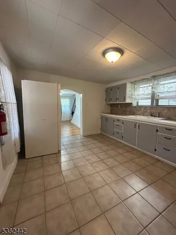 a large kitchen with a stove a sink and a refrigerator