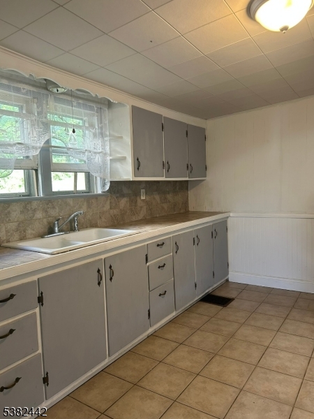 100 Myrtle Avenue Washington, NJ 07882 - Photo 16 of 37 a kitchen with a sink and cabinets