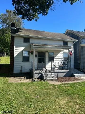 a view of a chair and table in backyard of the house