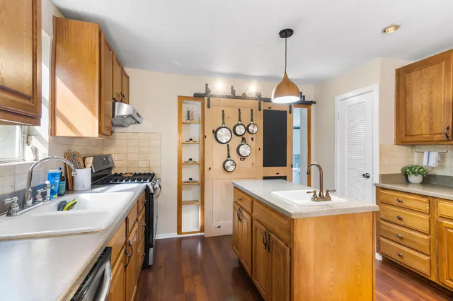 a kitchen with a sink stove and refrigerator