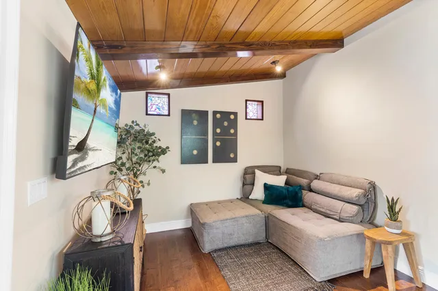 a living room with furniture and a chandelier