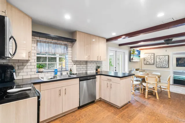 a kitchen with stainless steel appliances a refrigerator a stove and a sink