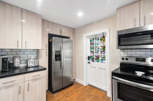 a living room with furniture a wooden floor and a sink