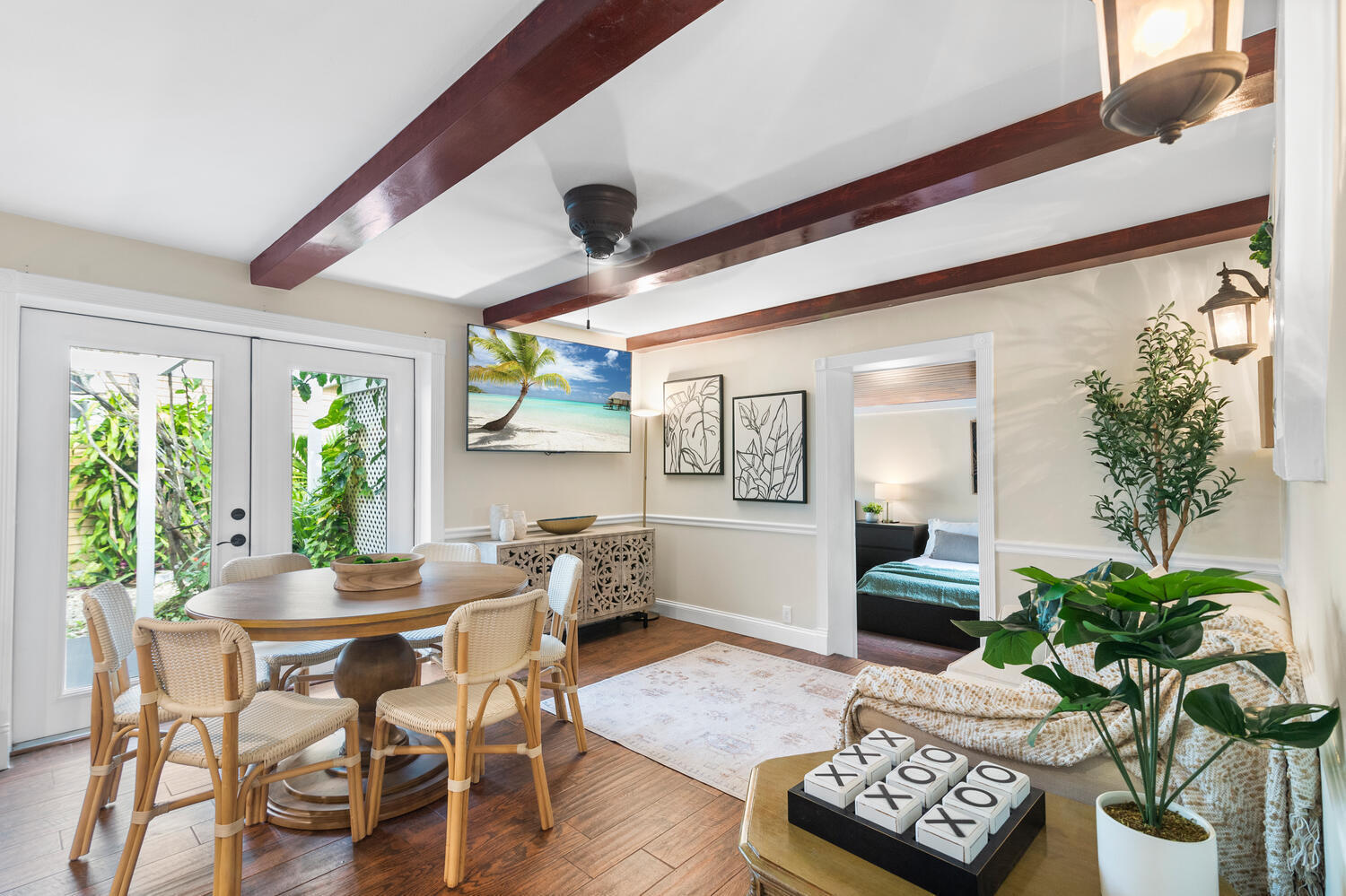 303 Lang Road Cloud Lake, FL 33406 - Photo 26 of 38 a dining room with furniture potted plants and wooden floor