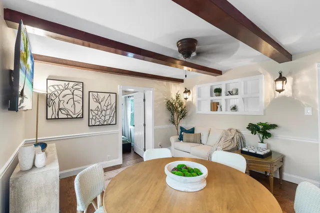 a living room with furniture and kitchen view