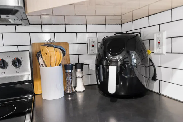 a view of swimming pool with a potted plant and floor to ceiling window