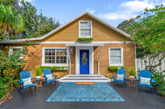 a view of a house with a chairs in patio