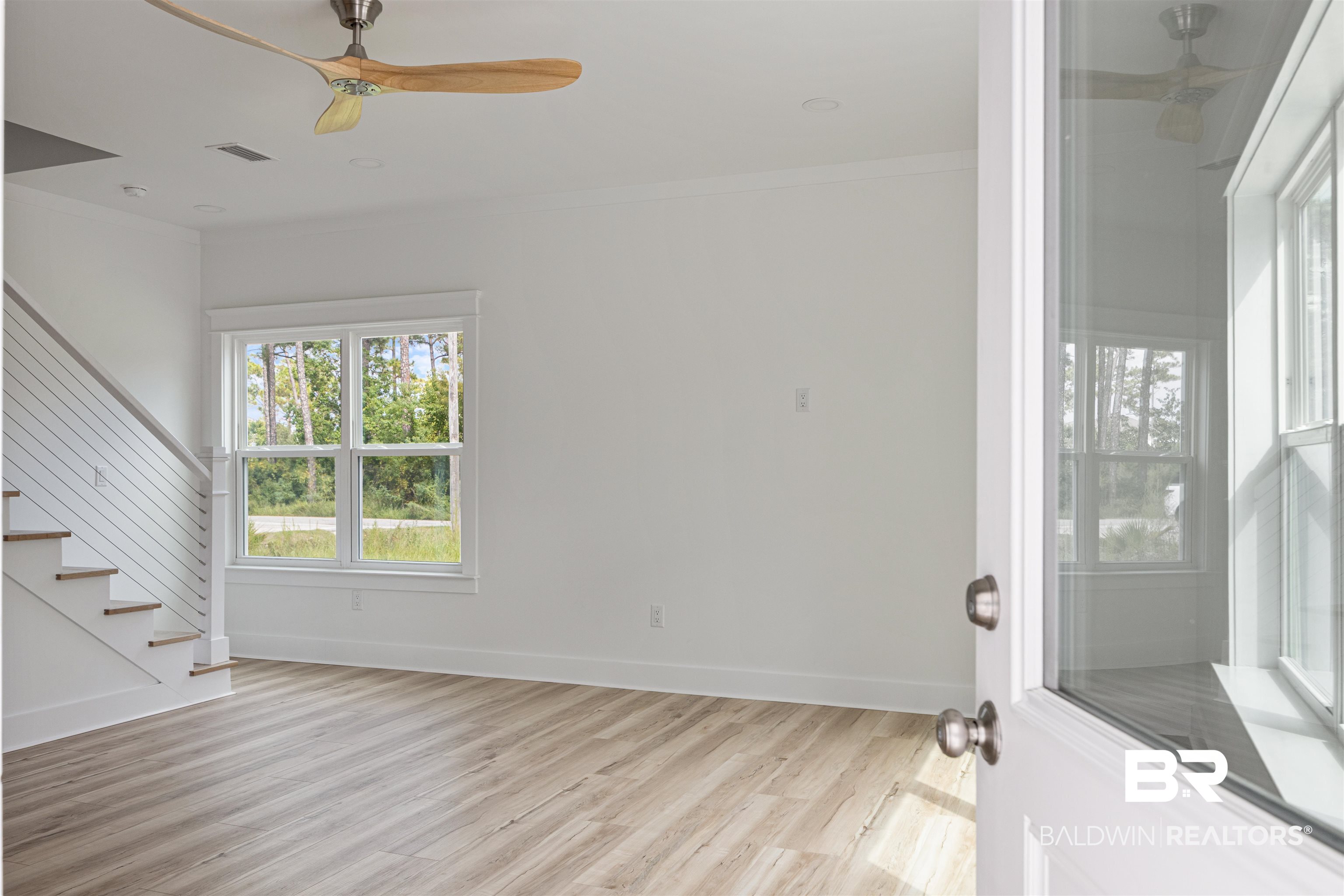 27591 Canal Road Orange Beach, AL 36561 - Photo 7 of 51 Entryway with a ceiling fan, stairway, light wood finished floors, and ornamental molding