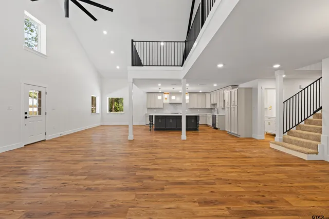 a view of a room with wooden floor and chandelier