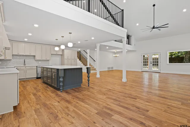 a kitchen with granite countertop white cabinets and white appliances