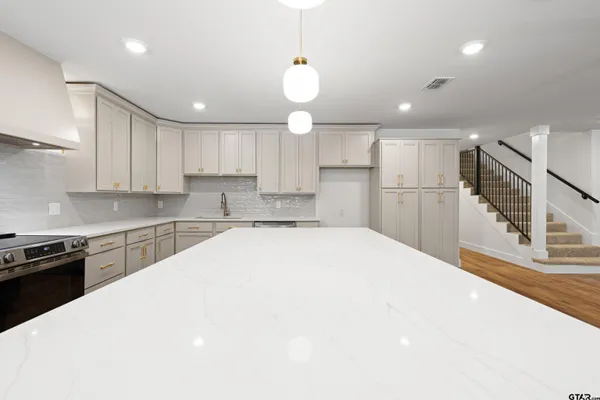 a kitchen with a stove and a sink