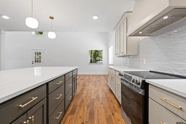 a kitchen with a sink cabinets and window