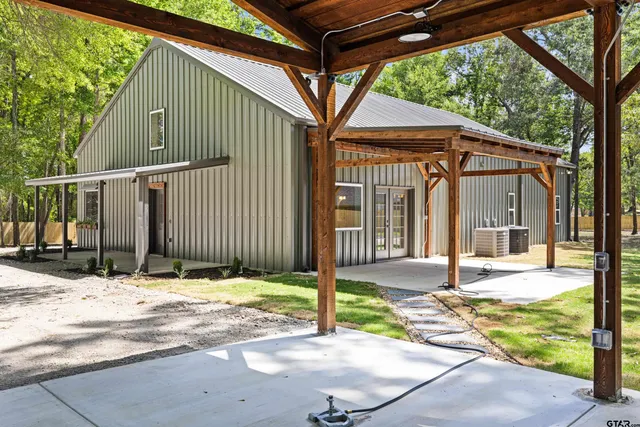 a backyard of a house with table and chairs
